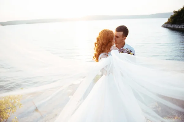 beautiful lovely blonde bride and groom classy on the rocks, ami