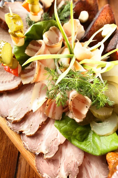 Sliced meat with different greens — Stock Photo, Image