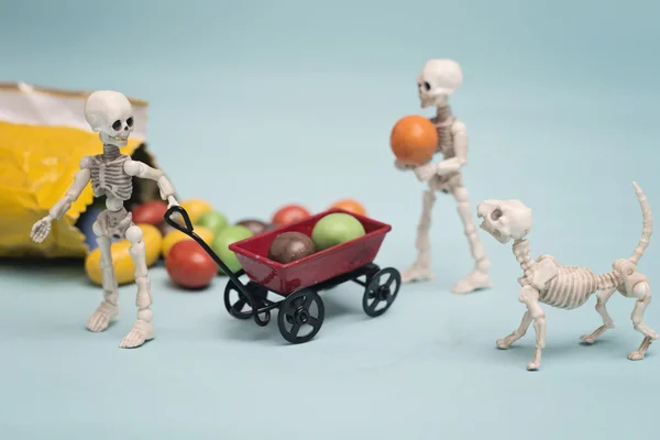 Skeleton kids and chocolate candy — Stock Photo, Image