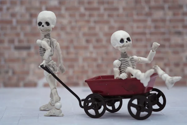 Skeleton kids and toy wagon — Stock Photo, Image