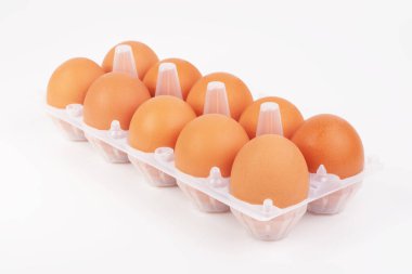 Beyaz arka planda yumurta tepsisindeki taze tavuk yumurtaları.