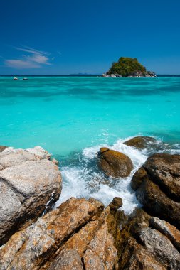 Island In Crystal Clear Aqua Ocean