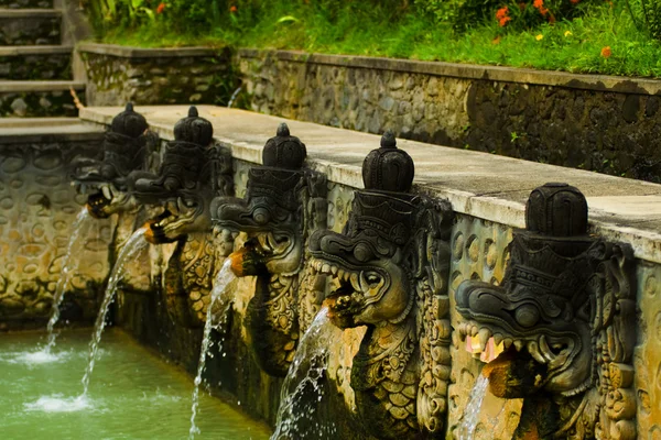 Bali heiße Quelle geschnitzte Brunnen Köpfe — Stockfoto