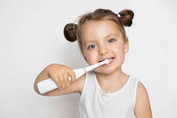 Eliminación perfecta de la placa con un cepillo de dientes modernoBonita niña limpiando dientes con cepillo de dientes sónico eléctrico. — Foto de Stock