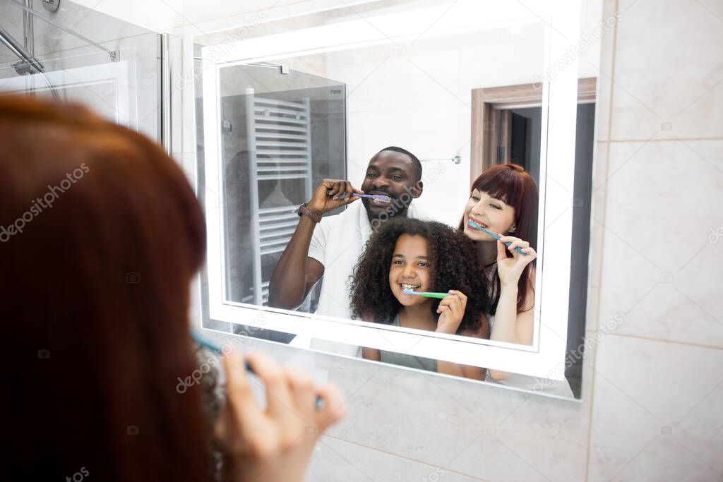 Family having fun while cleaning teeth together