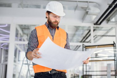 Bina çizimleriyle içeride poz veren yakışıklı bir sanatçı.