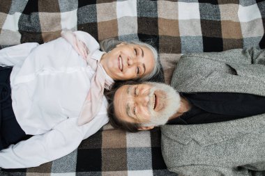 Olgun çiftin kafa kafaya battaniyenin üzerinde yatışının en üst görüntüsü.