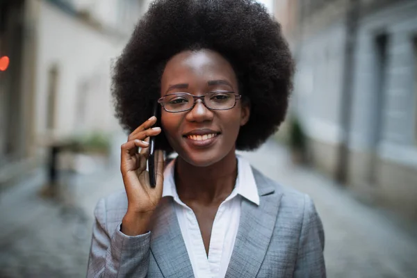 Portret van een Afrikaanse dame in pak in gesprek op mobiel — Stockfoto