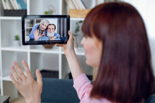 Woman having video chat with grandparents on tablet