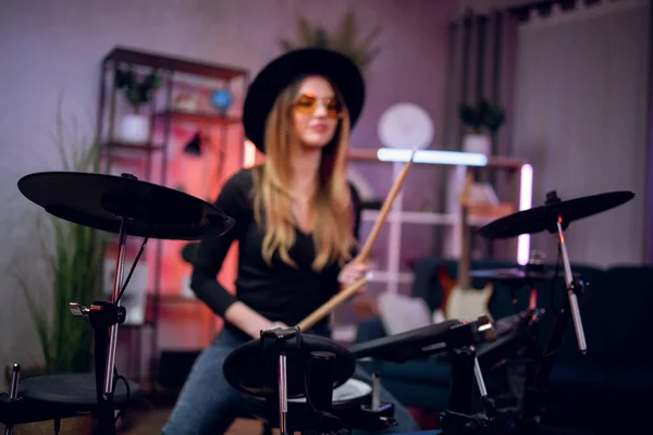 Woman using electronic drums for recording sound