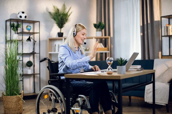 Woman with special needs having video call on laptop