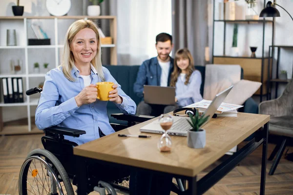 Kocası çocukla oynarken lapotp kullanan engelli kadın