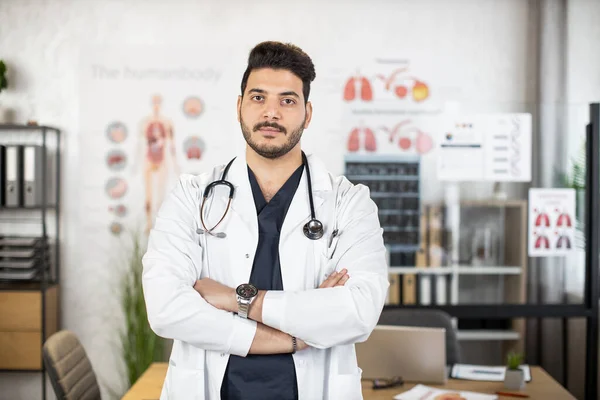 Portrait of confident Arabian male doctor posing at cabinet — Stock Photo, Image