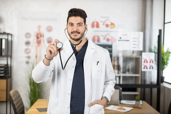 Indian doctor holding stethoscope and smiling on camera — Stock Photo, Image