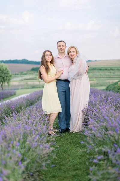 Happy family, posing together in lavender field — Stock Photo, Image