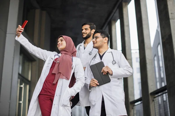 Arabian medical team making selfie photo on smartphone outside — Stock Photo, Image