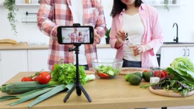 Bir çift mutfakta yemek pişirme dersi çekiyorlar. Sebzeli ve yağlı taze bir salata hazırlıyorlar.