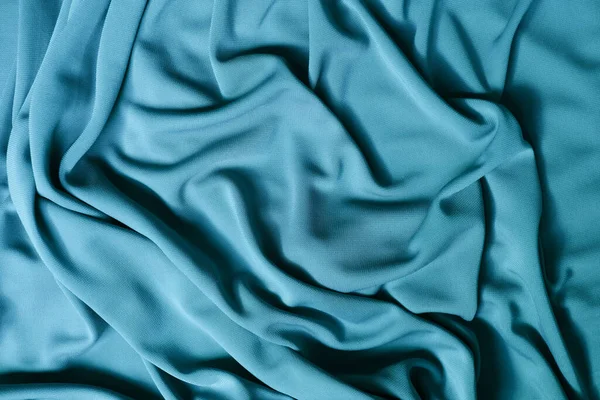 Smooth elegant blue satin texture abstract background. Luxurious background design. Closeup texture