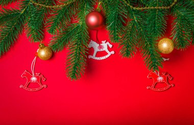 Köknar dalı ve oyuncakları olan kırmızı Noel kartı