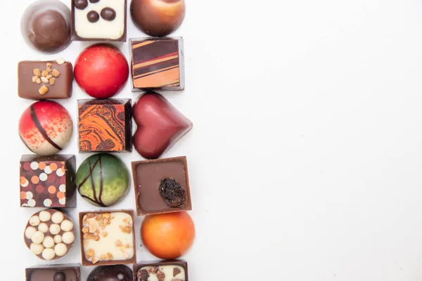 lot of variety chocolate pralines, top view of various chocolate pralines isolated on white background,