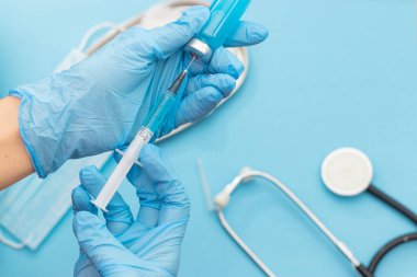 COVID-19 aşı şişesi ve Coronavirus enfeksiyonuna karşı şırınga enjekte eden doktor elinde. Tıbbi, sağlık, aşılama ve aşılama kavramı