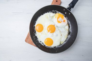 Scrambled eggs in frying pan. National Ukrainian or belorussian food. Breakfast, lunch. Top view, selective focus, rustic style