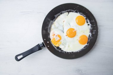 Scrambled eggs in frying pan. National Ukrainian or belorussian food. Breakfast, lunch. Top view, selective focus, rustic style