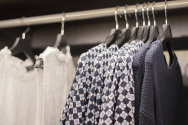 Clothes Hanging On A Rack. Shopping and space organization, minimalist.