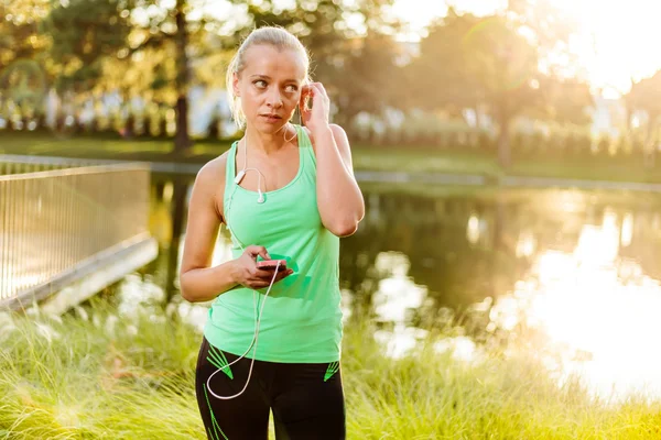 Kvinna med mobiltelefon redo för utbildning i stadsparken — Stockfoto