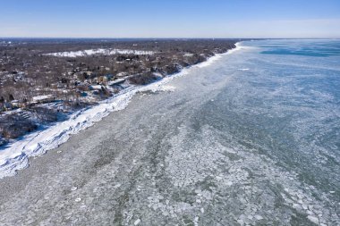 Aerial view of an icy Lake Michigan along the shoreline of Glencoe Beach after an intense cold spell. clipart
