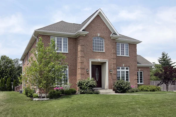 Brick home with arched window — Stock Photo, Image