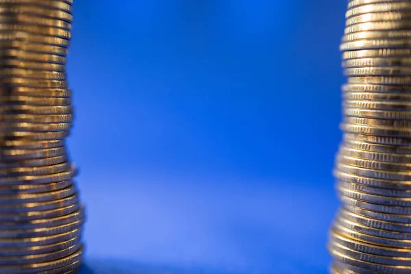 Business, Money and Financial Concept. Closeup of two stack of gold coins on blue background with copy space.