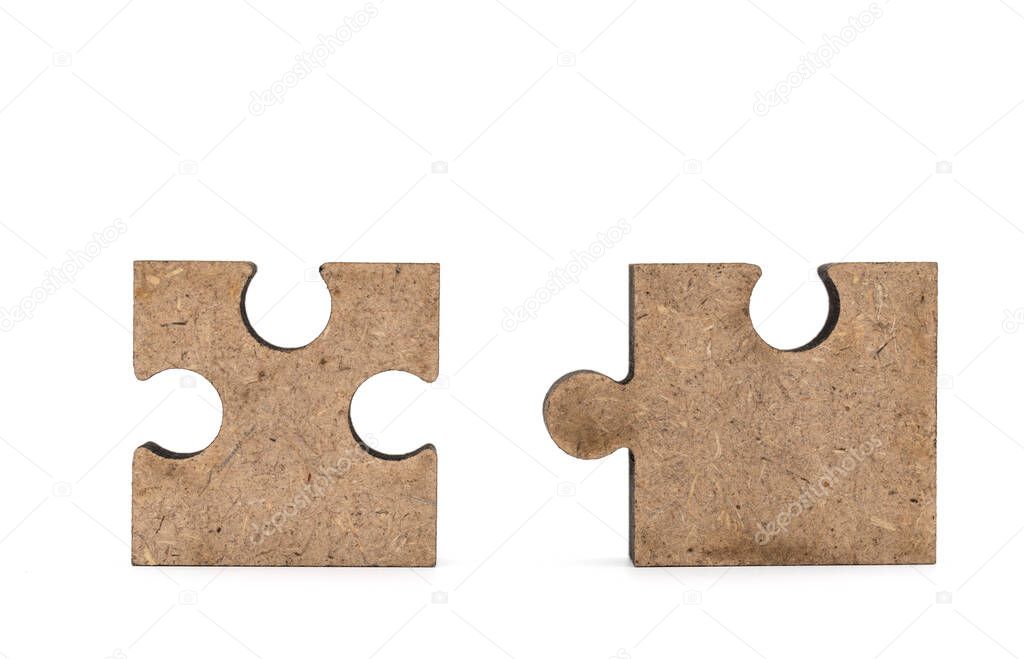 Business and Solution Concept. Closeup of two wooden jigsaw puzzle cutout isolated on white background.