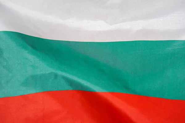 Fabric texture flag of Bulgaria. Flag of Bulgaria waving in the wind. Bulgaria flag is depicted on a sports cloth fabric with many folds. Sport team banner