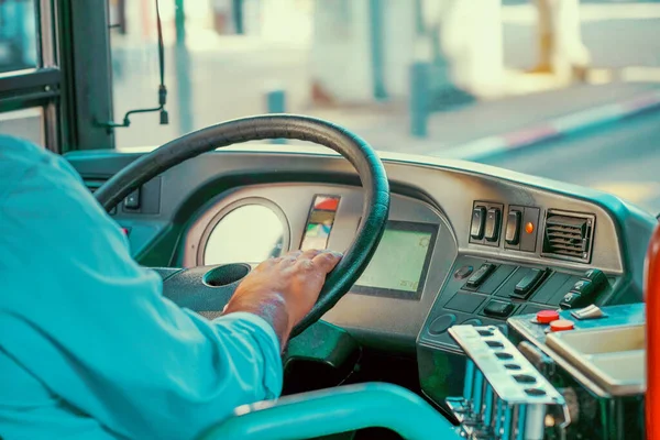 Concept of bus driver steering wheel and driving passenger bus. Hands of driver in a modern bus by driving
