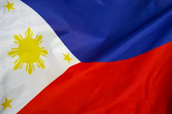 Fabric texture flag of Philippines. Flag of Philippines waving in the wind. Philippines flag is depicted on a sports cloth fabric with many folds. Sport team banner.