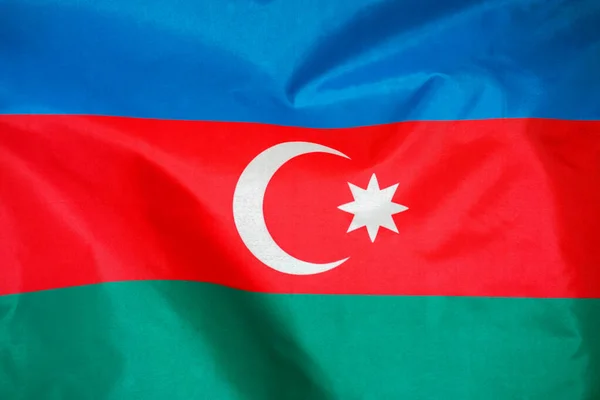 Fabric texture flag of Azerbaijan. Flag of Azerbaijan waving in the wind. Azerbaijan flag is depicted on a sports cloth fabric with many folds. Sport team banner