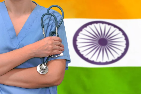 Female surgeon or doctor with stethoscope in hand on the background of the India flag. Surgery concept in India