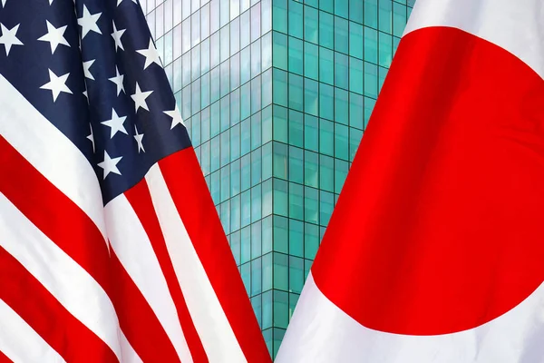 Flag of USA and Japan flag close-up. The concept of political and economic relations of states