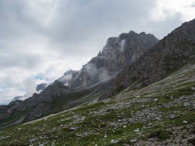 view on limestone moutain peak partialy covered by clouds at Stubai hiking trail, Stubai Hohenweg, Alpine landscape of Tirol Alps, Austria. Summer