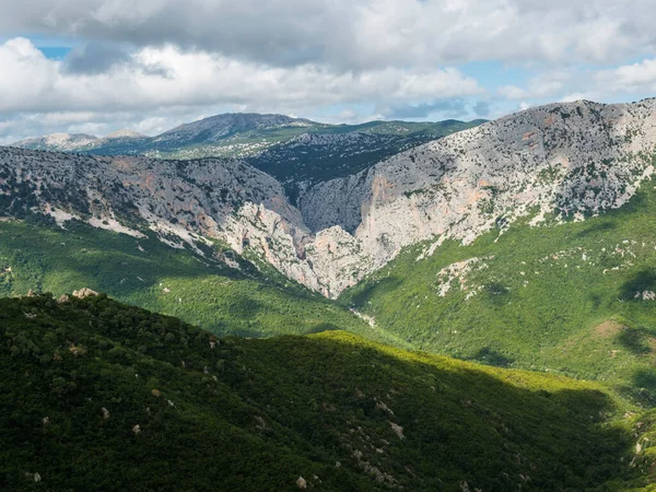 stock image View of Gola Su Gorropu gorge, famous hiking destinantion at green forest landscape of Supramonte Mountains with limestone rock and mediterranean vegetation, Nuoro, Sardinia, Italy. Summer cloudy day