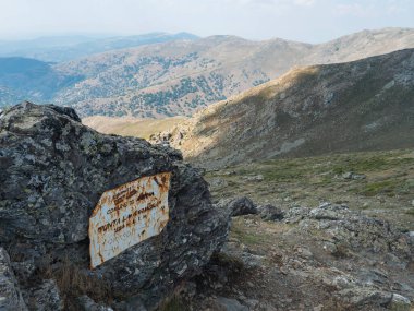 Gennargentu Dağı, Sardinya, İtalya, 12 Eylül 2020: Paslı metal uyarı işareti Punta La Marmora en yüksek dağ zirvesi kuru düzlükleri, tepeleri ve Akdeniz bitkileri ile vadileri. Mavi gökyüzü