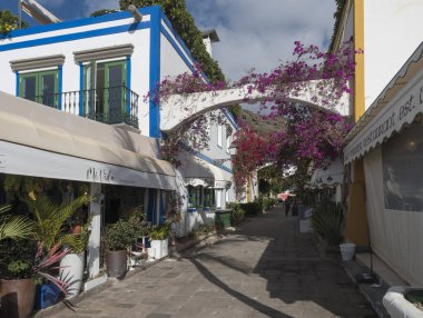 Puerto de Mogan, Gran Canaria, Kanarya Adaları, İspanya 18 Aralık 2020: Küçük balıkçı köyü limanı Puerto de Mogan 'ın yaya yolundaki geleneksel renkli evler.