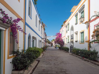 Puerto de Mogan, Gran Canaria, Kanarya Adaları, İspanya 18 Aralık 2020: Küçük balıkçı köyü limanı Puerto de Mogan 'ın yaya yolundaki geleneksel renkli evler.