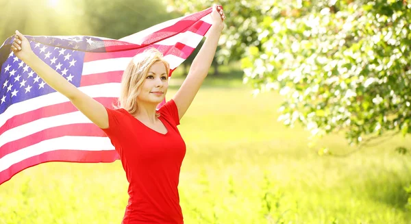 Patriotic young woman with American flag. Outdoor — Stock Photo, Image