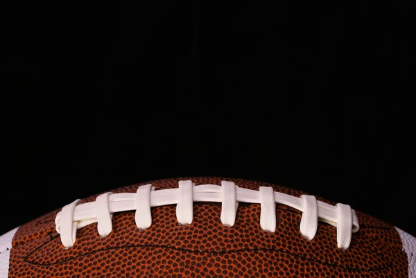 American Football. Ball over black background — Stock Photo, Image