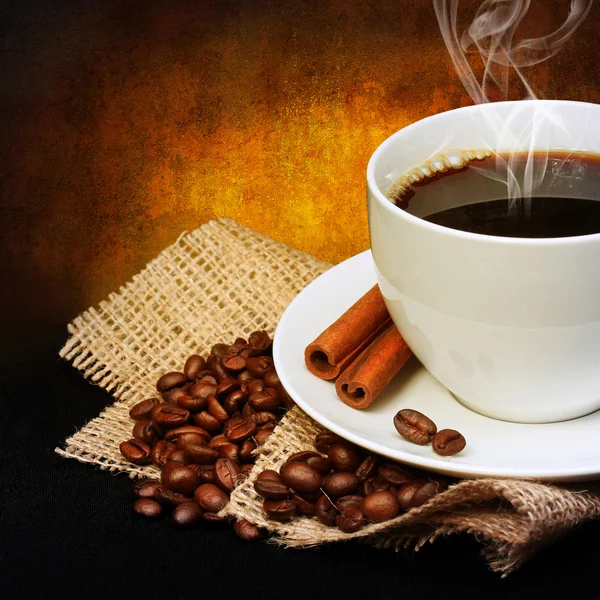 Kaffekopp med kaffebönor på säckväv — Stockfoto