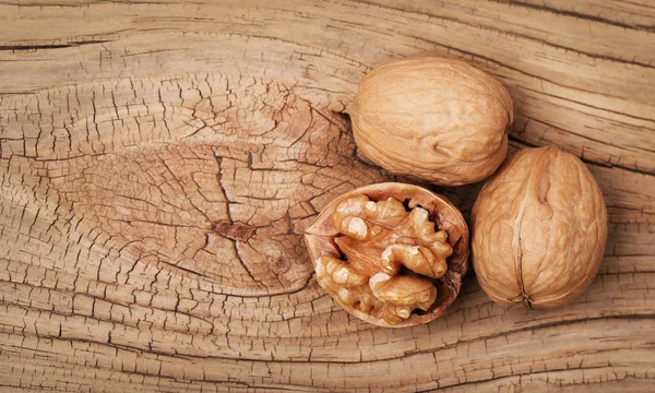 Walnuts on old wooden background — Stock Photo, Image