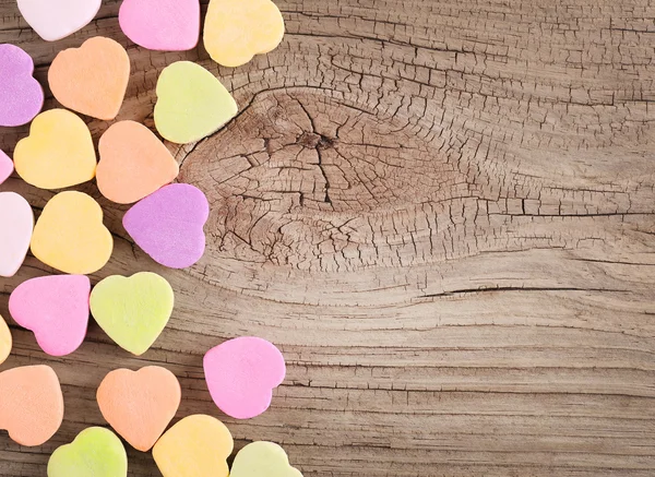 Coloridos corazones de caramelo sobre fondo de madera — Foto de Stock