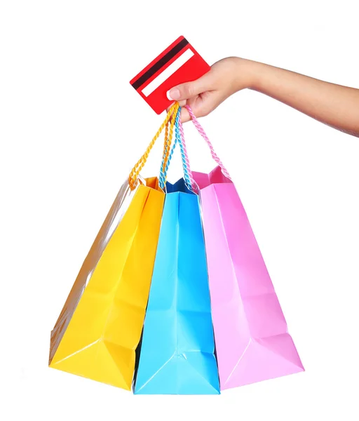 Bolsas de compras coloridas y tarjeta de crédito en mano femenina aislada —  Fotos de Stock